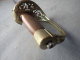 a metal object with a handle on a table