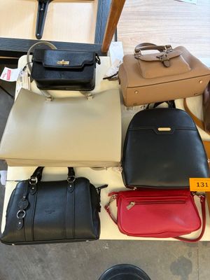 a lot of purses that are on a table