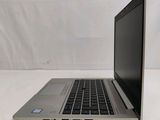 an open laptop computer sitting on top of a white table