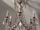 a crystal chandelier hanging from the ceiling in a room