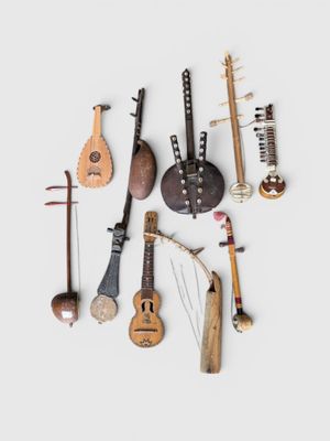 many musical instruments that are arranged together on a white surface