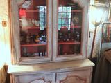 a china cabinet in the corner of a room
