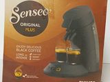 the box of a coffee machine is sitting on the table