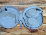 a pair of headphones in a case on a wooden table
