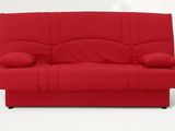 red futon sofa with pillows and pillows on top of it