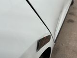 a close up of a car door handle with a sticker on it