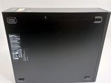 the back of a black box on a white surface with a logo on it