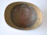 a metal bowl with a hole in it on a white surface