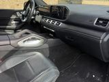 the interior of a car with the door open and the driver ' s seat down