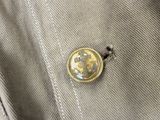 a button on the back of a jacket that has a picture of a horse on it