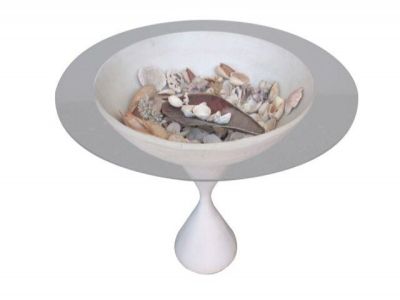 a white bowl with shells in it on a pedestal