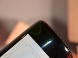 a bottle of wine sitting on a table next to a stack of books