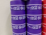several stacks of purple and red plastic containers sitting on top of a white table