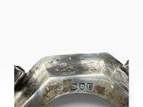a close up of a metal object on a white surface
