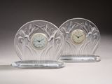 two glass clocks sitting on top of each other