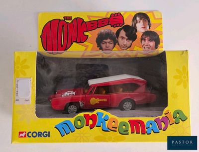 a red toy car in a yellow box with a picture of the beatles
