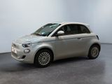 an image of a silver smart car in a showroom