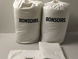 two bags of bonsors sitting on top of a table next to each other