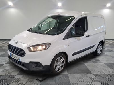 la camionnette blanche est garée sur un sol carrelé en damier