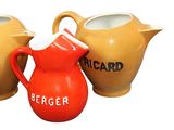 three different colored jugs sitting next to each other