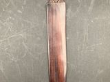a knife with a face carved into it on a table