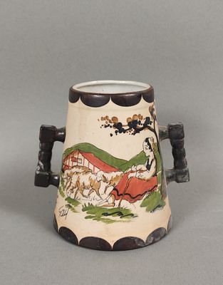 a vase with a painting on it sitting on a table