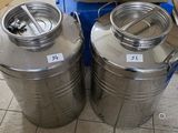 two stainless steel tanks sitting next to each other on the floor