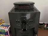 a coffee maker sitting on a table next to a box of coffee beans