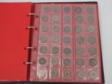 a red binder with a lot of coins inside of it