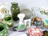 many different types of vases and bowls on the table