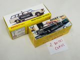 two boxes of dinky toys sitting on a table