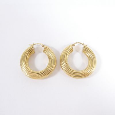 a pair of gold hoop earrings on a white background