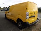 the back of a yellow van parked on the side of the road