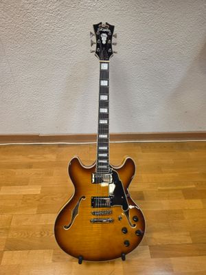 an electric guitar sitting on top of a wooden floor next to a wall