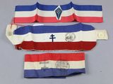 three pieces of red, white, and blue striped cloth with a cross on it