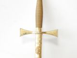 an image of a gold and black sword hanging on a wall