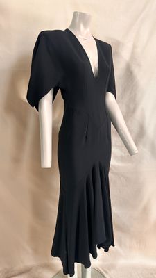 an image of a black dress on a mannequin base