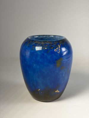 a blue vase that is sitting on a table