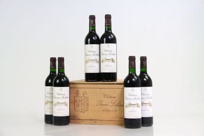 four bottles of red wine in a wooden box on a white surface