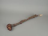 an image of a wooden stick with a carved head on it