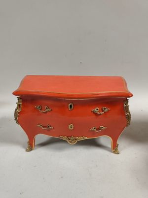 pair of orange and gold painted chest of drawers