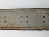 a metal tray with holes in it on a white surface