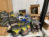many bags of food on a table with a cat in the background