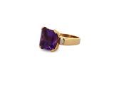 a close up of a ring with a purple stone on it