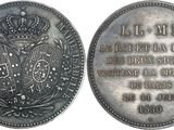 an old silver coin with a crown on the front and a plaque on the back