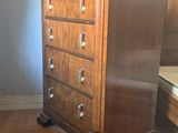 a wooden chest of drawers in the corner of a room