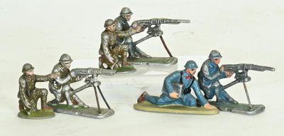 several figurines of soldiers with guns on a white surface