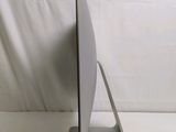 a computer monitor on a stand on a white surface