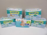 four packs of baby diapers sitting on top of a table
