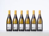 six bottles of white wine lined up in a row